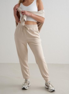 Damskie spodnie dresowe regular fit, ściągacze Comfy Modal beżowe