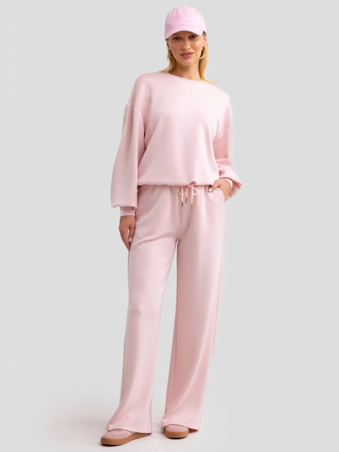 Spodnie damskie dresowe z szeroką nogawką jasnoróżowe Lunarap 600