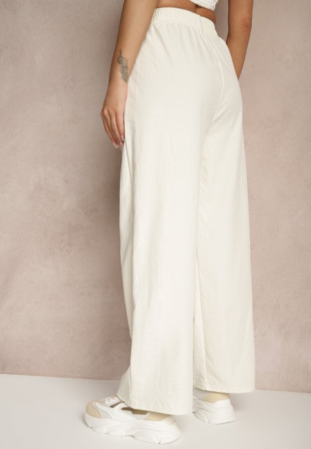 Jasnobeżowe Spodnie o Szerokim Kroju z Bawełną High Waist Ozdobione Naszywką Naneriela