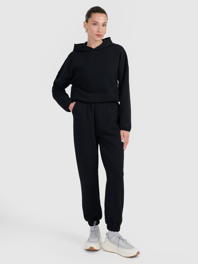 4F Spodnie dresowe z waflowej dzianiny damskie - czarne XS