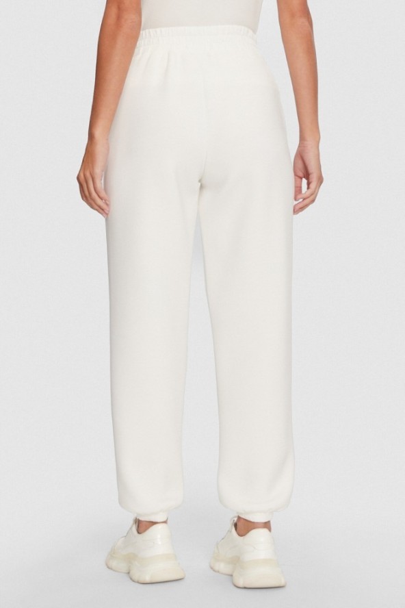 GUESS Dresowe damskie spodnie w kolorze ecru Cecilia Scuba, Rozmiar S