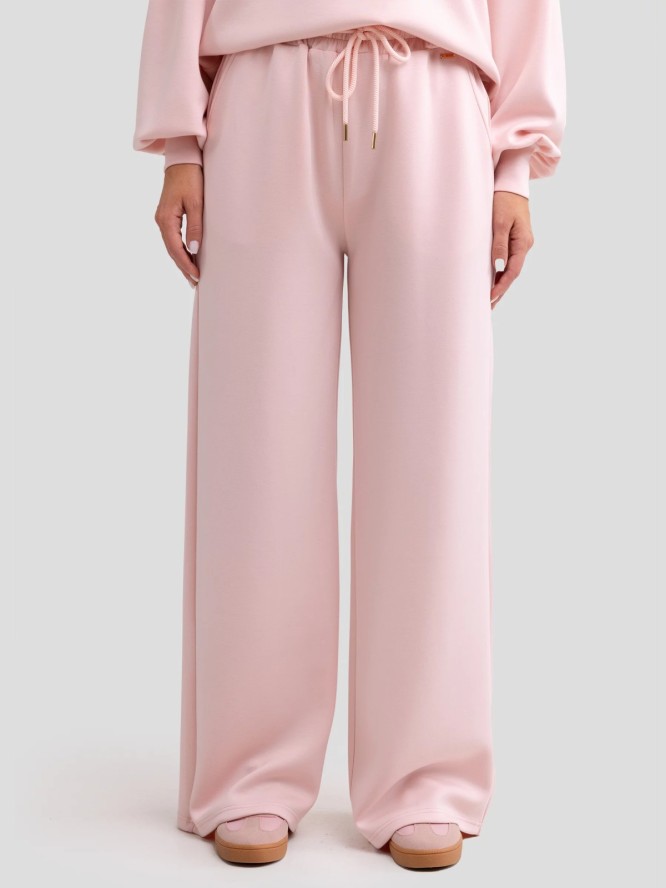Spodnie damskie dresowe z szeroką nogawką jasnoróżowe Lunarap 600