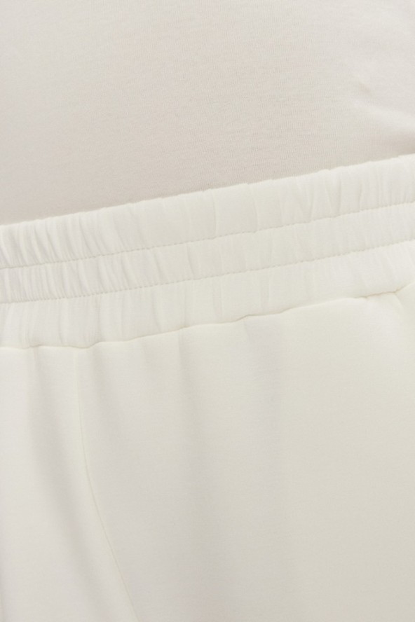 GUESS Dresowe damskie spodnie w kolorze ecru Cecilia Scuba, Rozmiar S