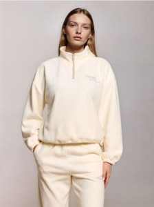 Polarowa bluza z krótkim zamkiem i regulowanym stoperami dołem - kremowy