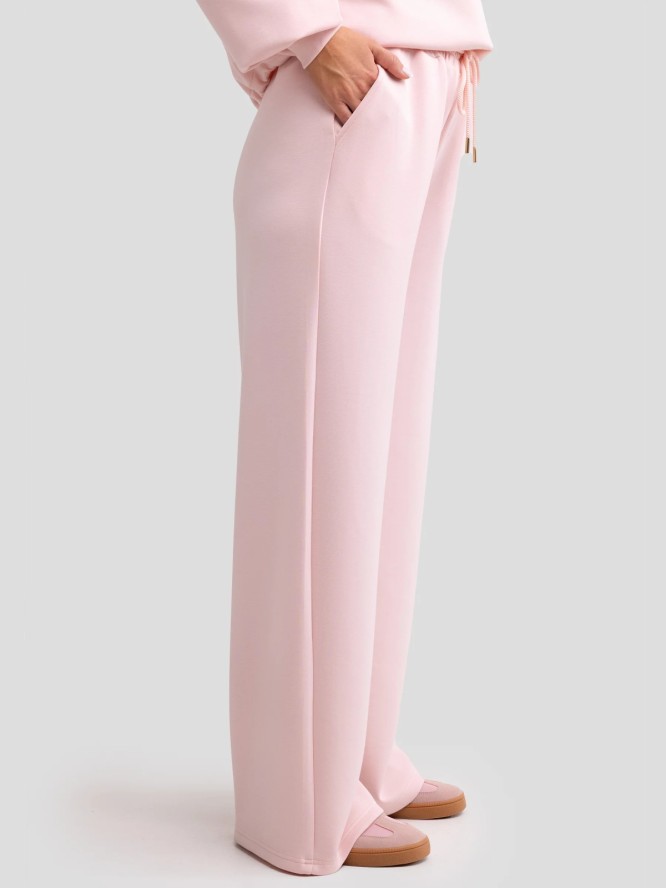 Spodnie damskie dresowe z szeroką nogawką jasnoróżowe Lunarap 600